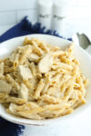 a bowl of Alfredo sauce with penne pasta