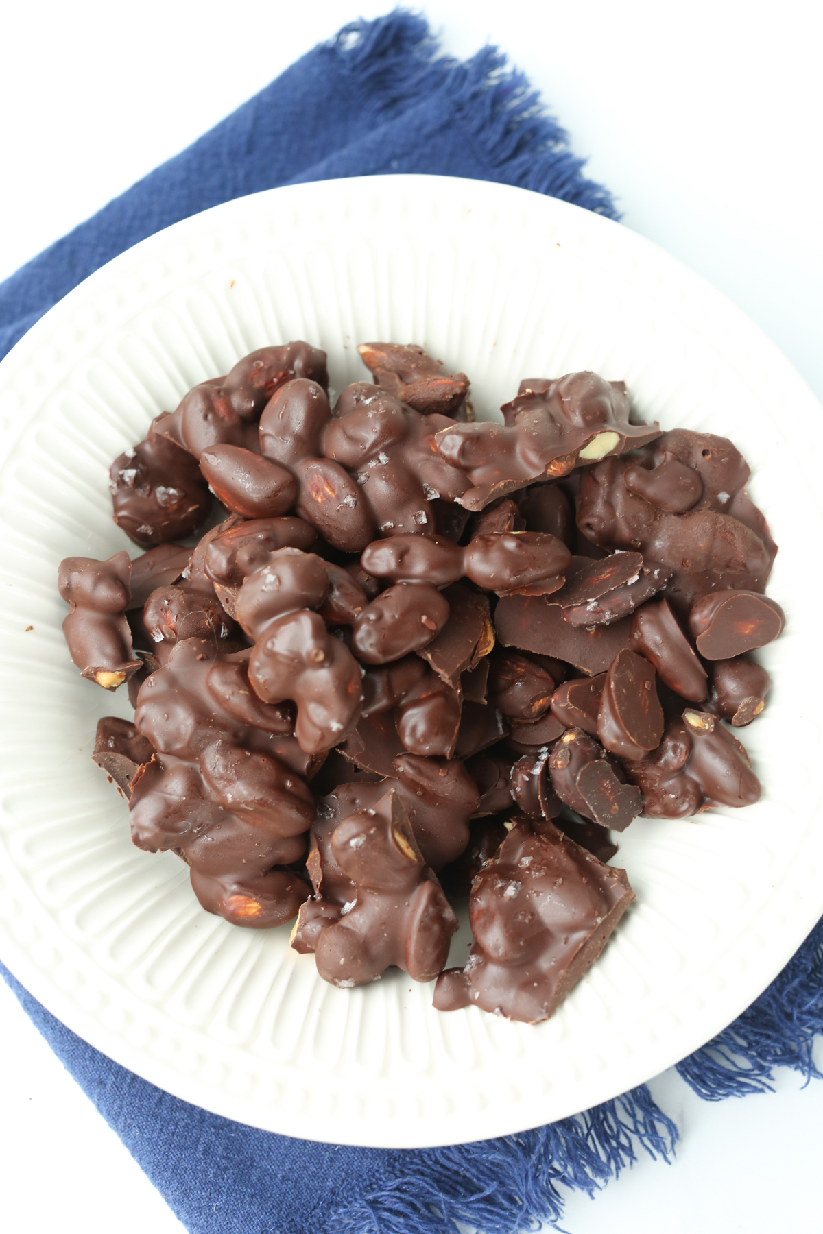 a bowl of almonds covered in chocolate