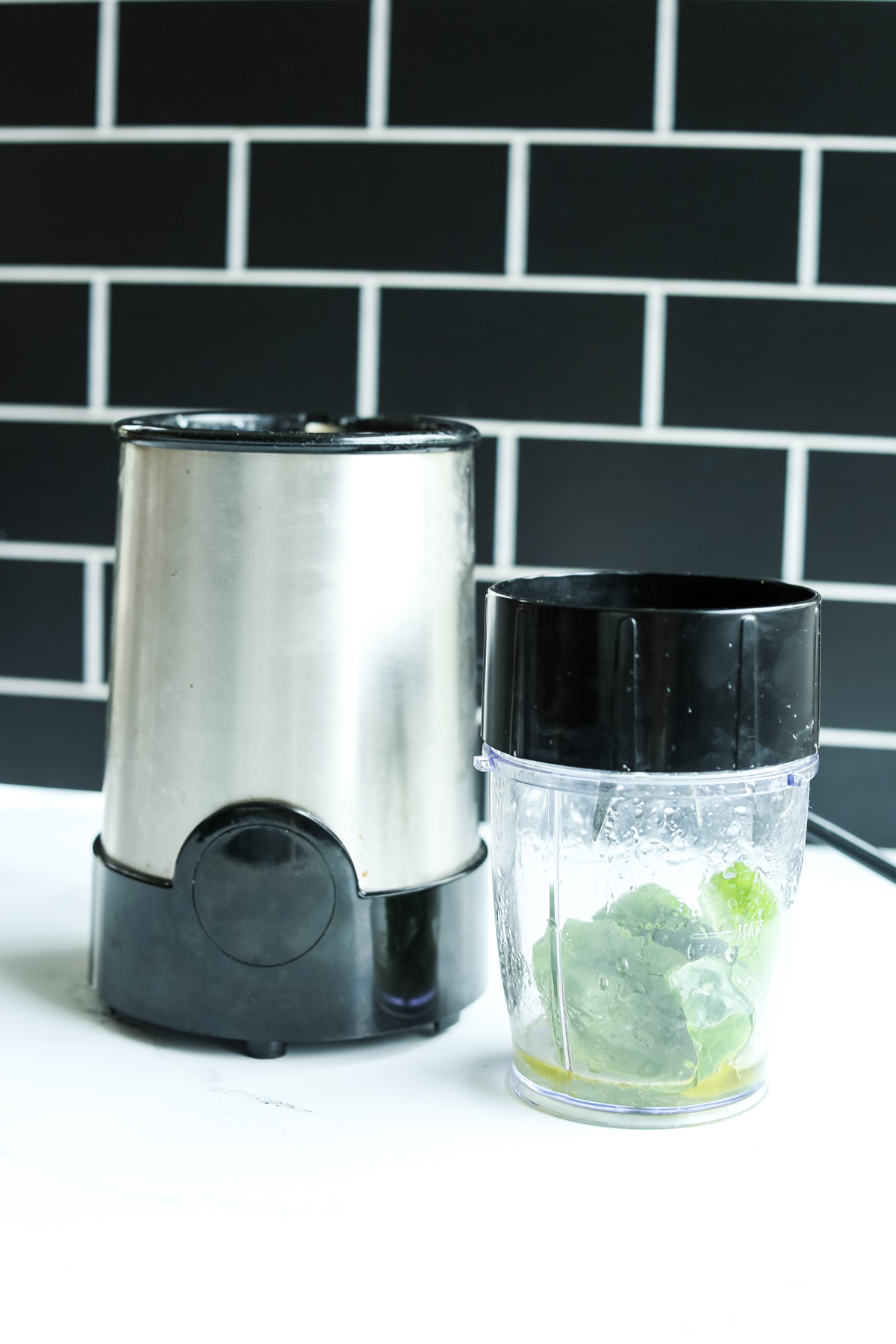 a small blender with dressing ingredients in the container