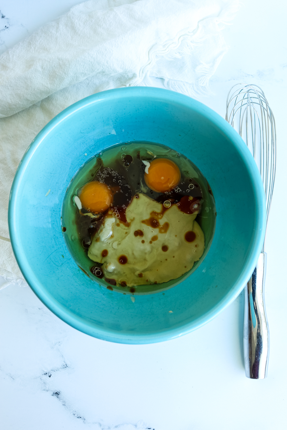 wet ingredients in a turquoise bowl