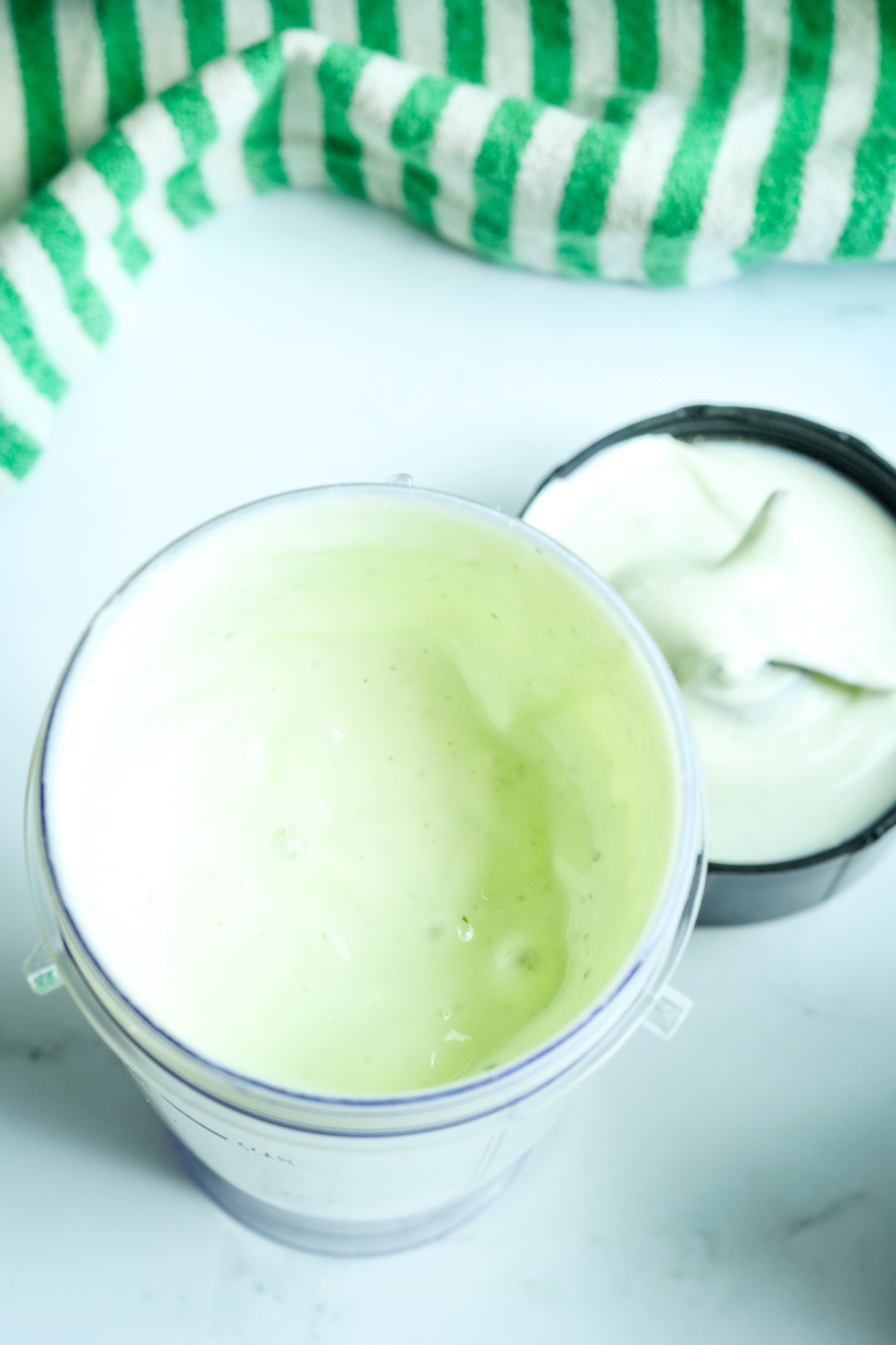 a creamy green hued dip in a small blender