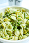 Orecchiette Pasta with asparagus, peas, and pesto in a bowl close up photo