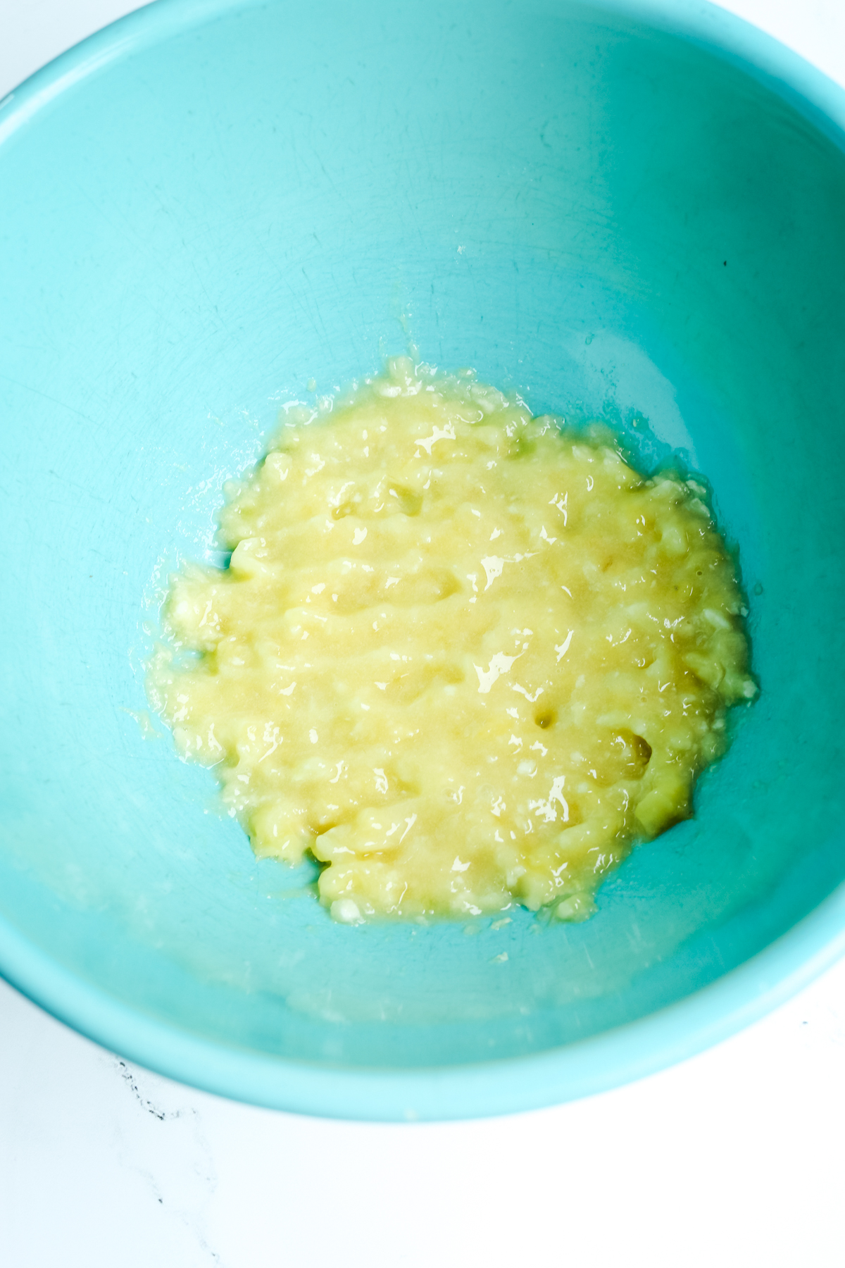 Mashed banana in a turquoise blue bowl