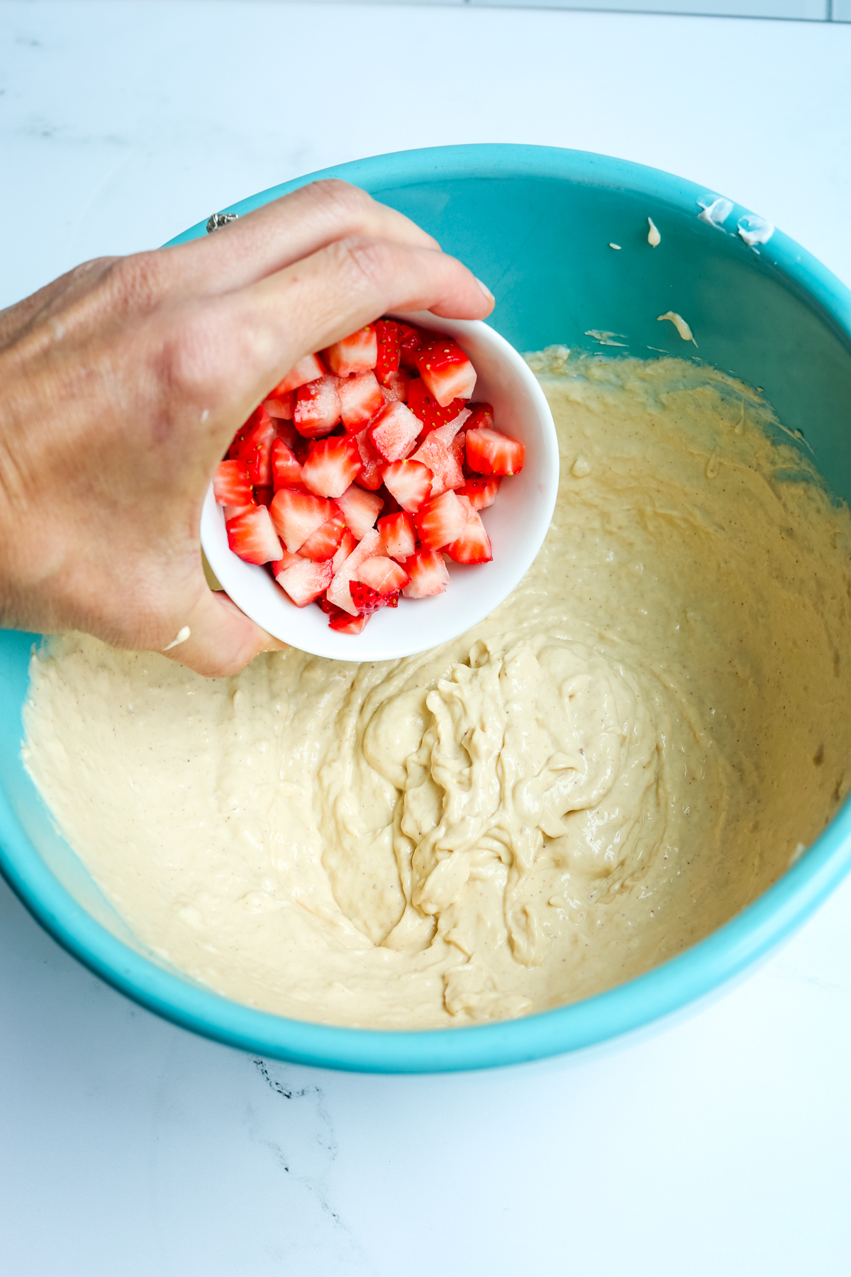 Adding strawberry pieces to the mixture