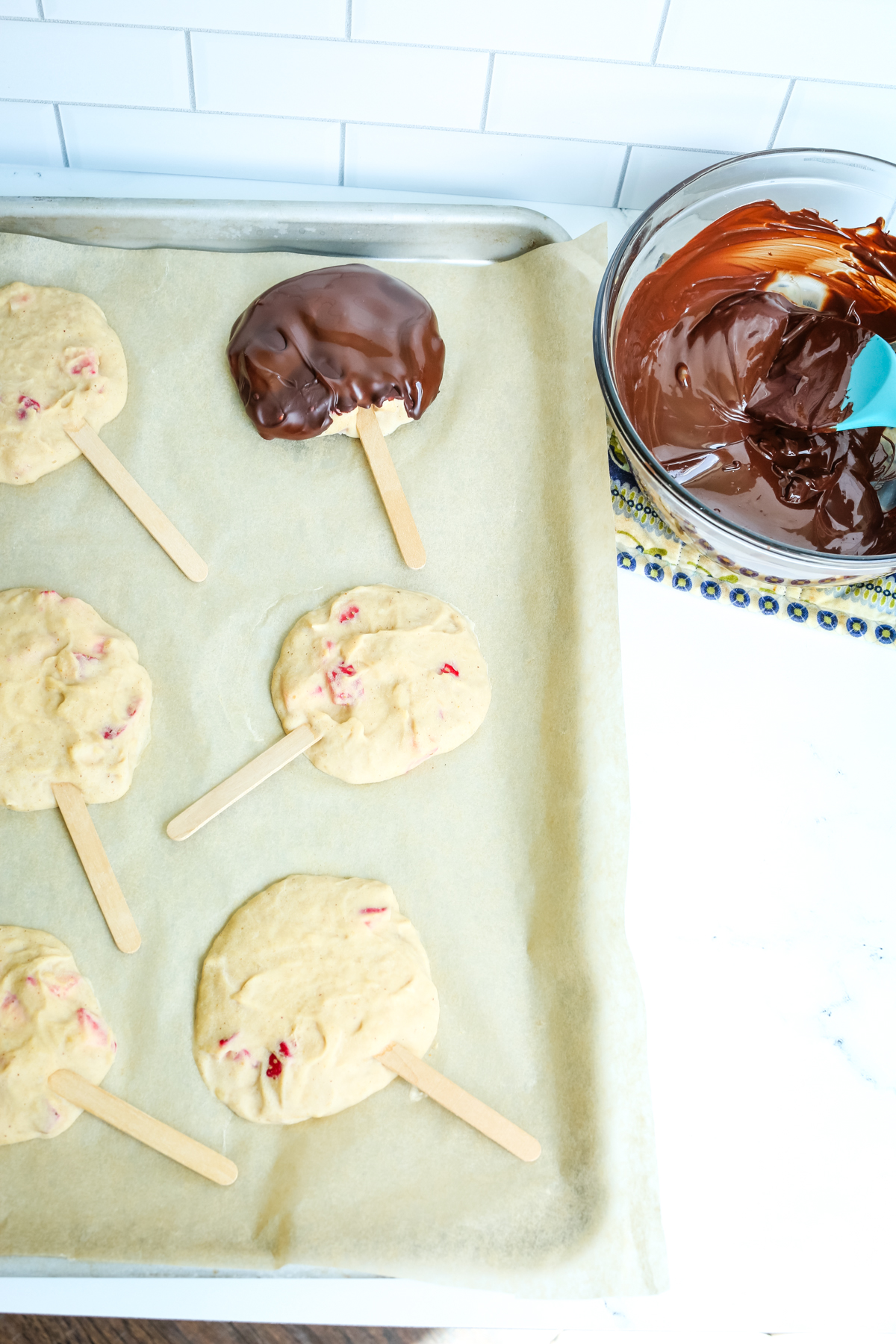 dipping frozen greek yogurt bars into melted chocolate