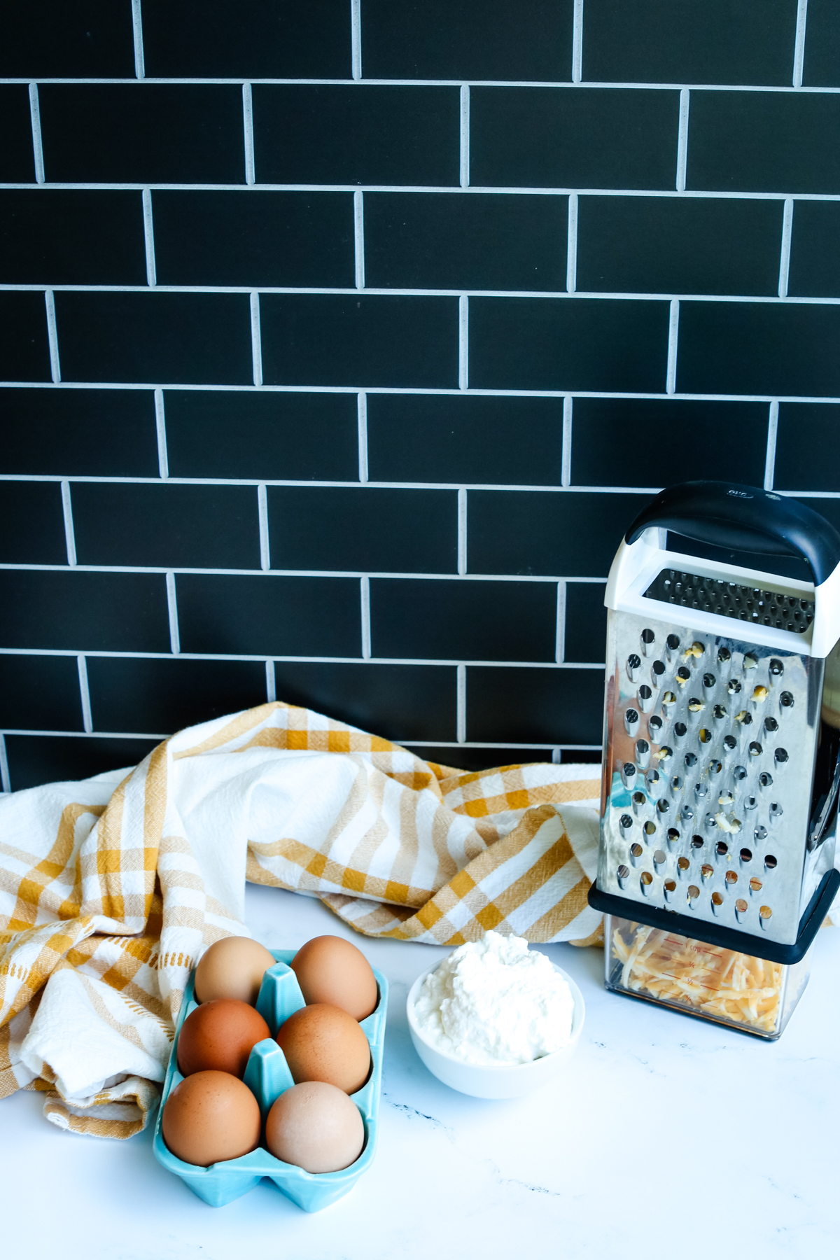 eggs, shredded cheese, and cottage cheese with a towel 