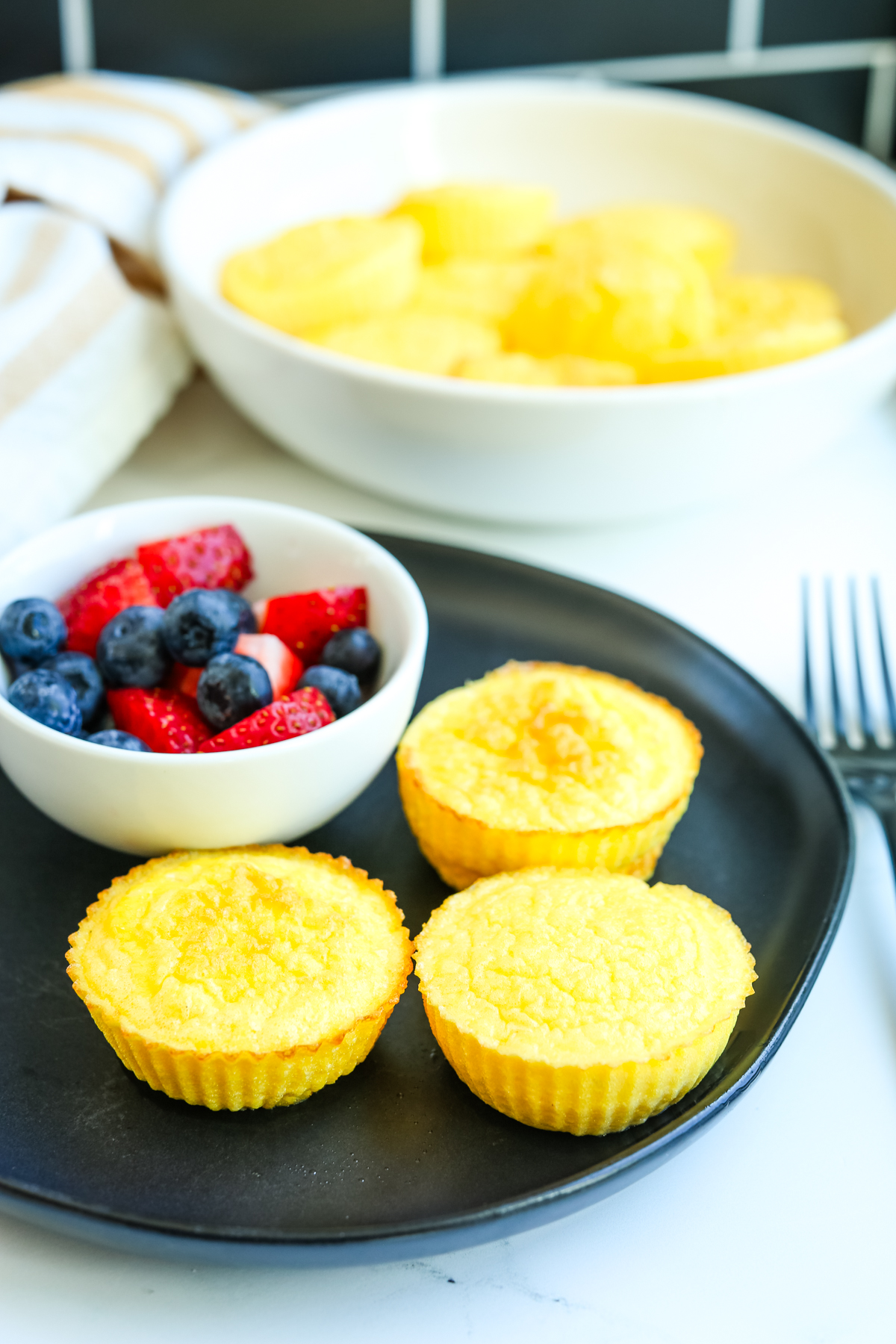 a plate with egg muffins and fruit 