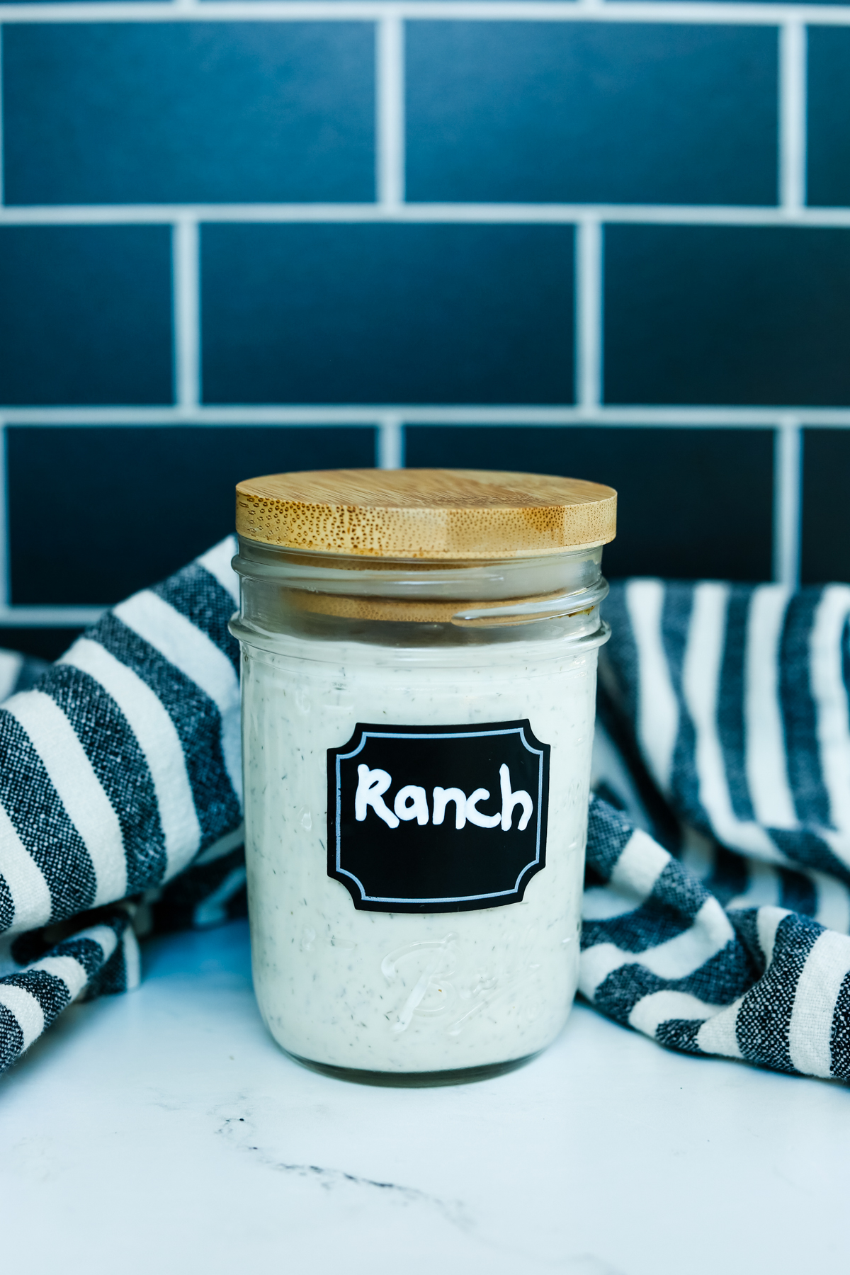 A mason jar with a wooden lid and "Ranch" on a label