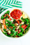 Harissa Chicken bowl with a green and white striped napkin