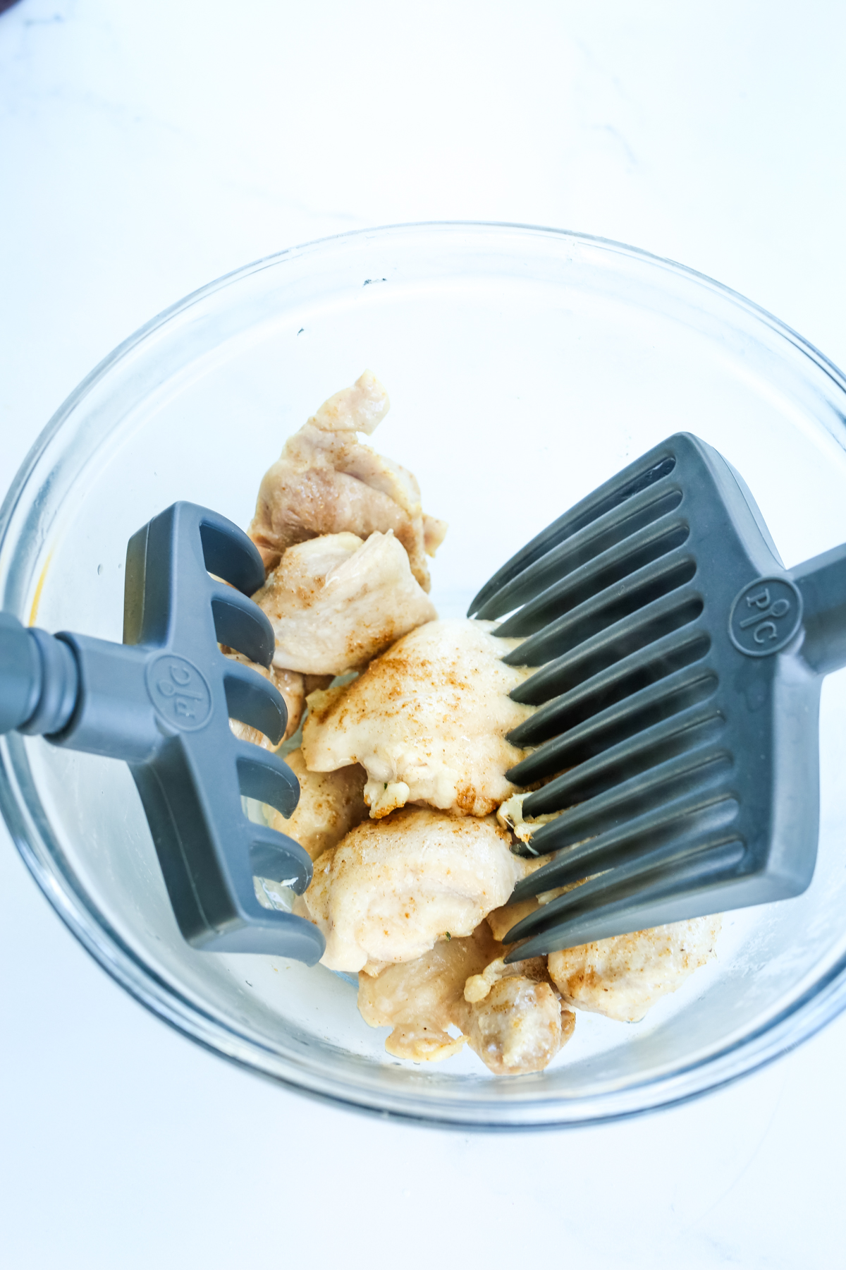 shredding chicken in a bowl