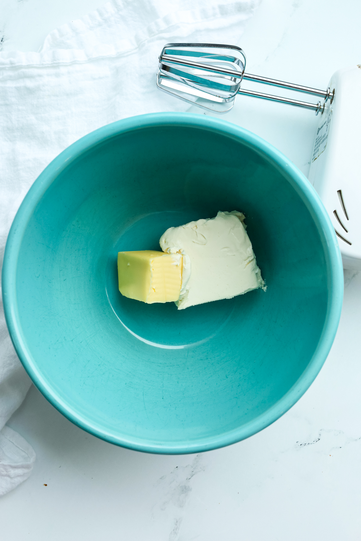 butter and cream cheese in a blue bowl