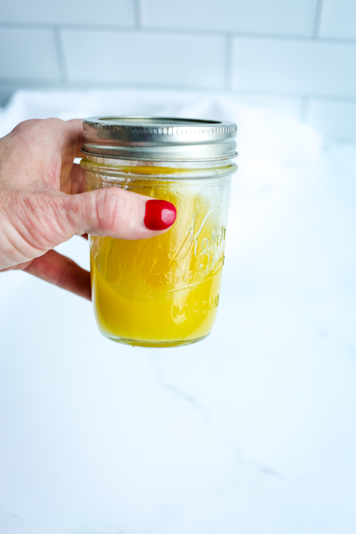 shaking the dressing in a mason jar
