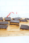 a number of chocolate peanut butter protein bars on a cutting board