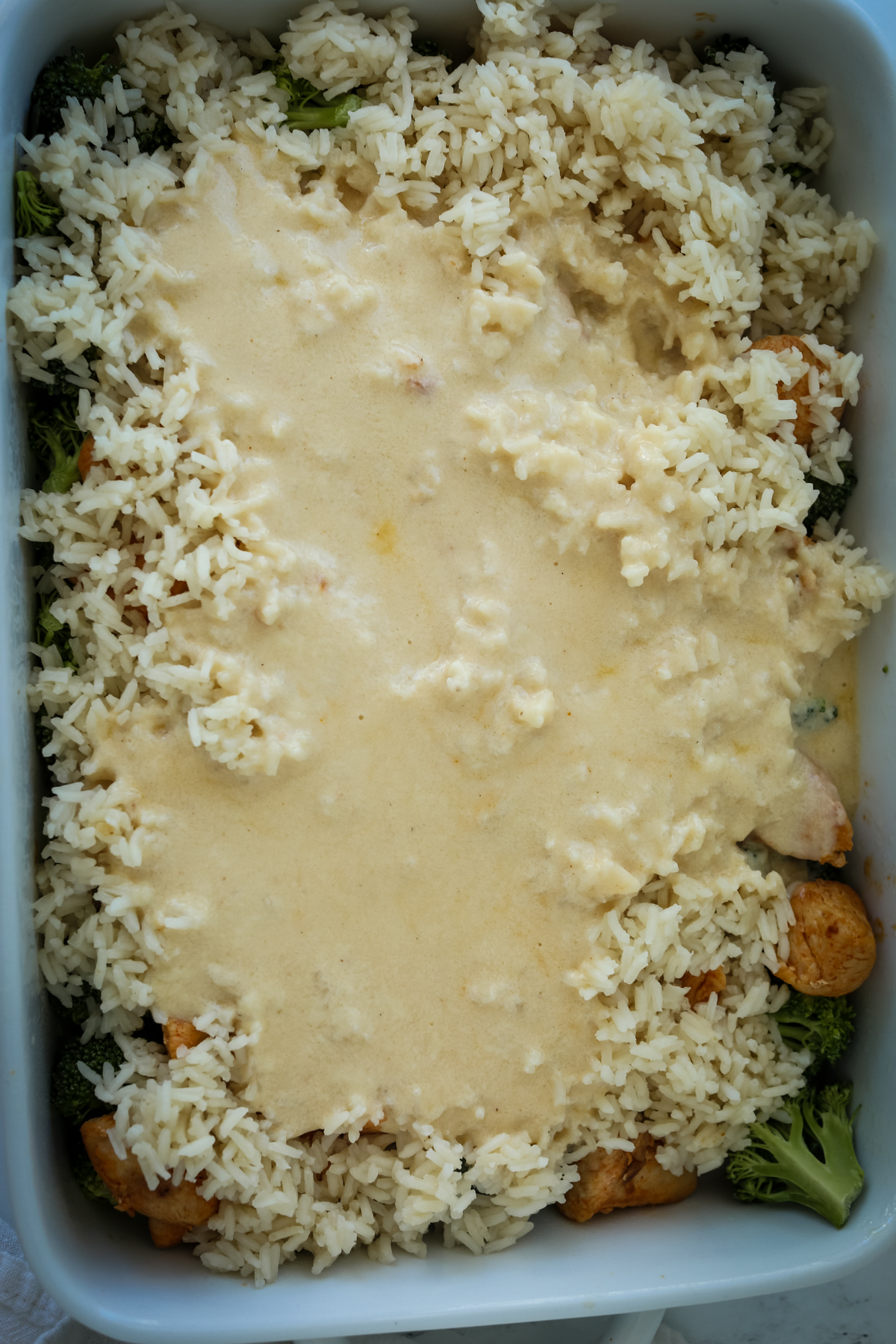 sauce over rice in a casserole dish