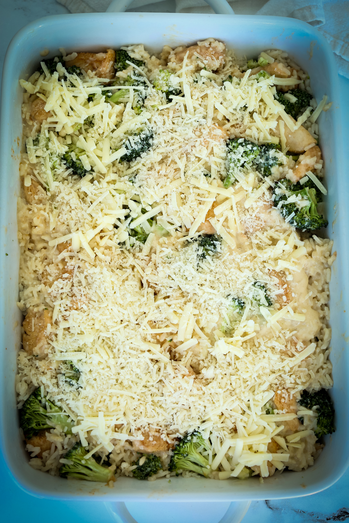 all the ingredients for broccoli chicken rice casserole in the dish before baking