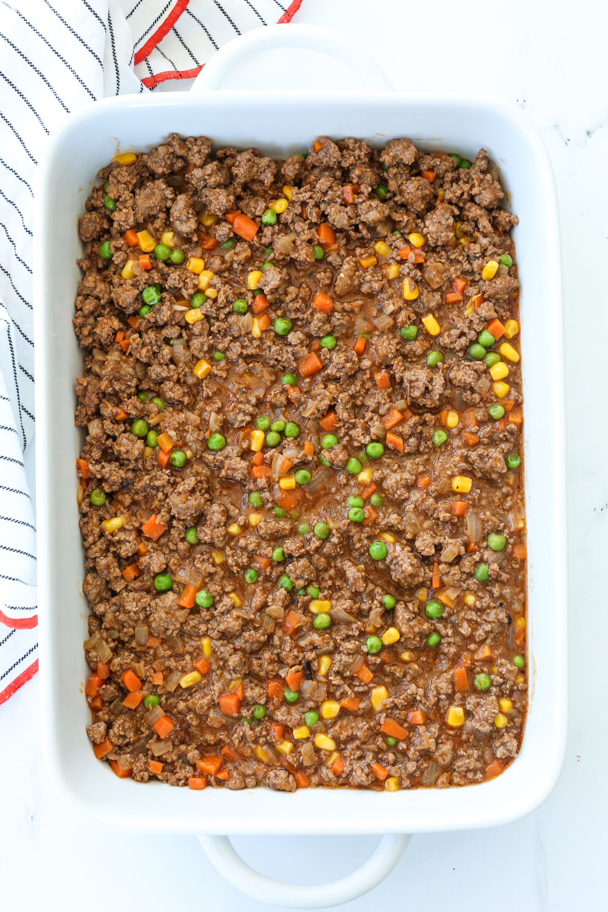 a meat and vegetable mixture in a casserole dish