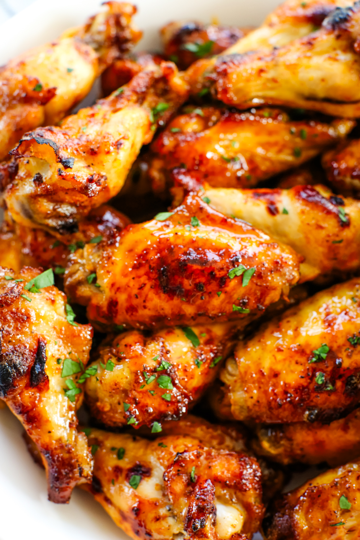 a close up shot of a bowl of hot honey chicken wings