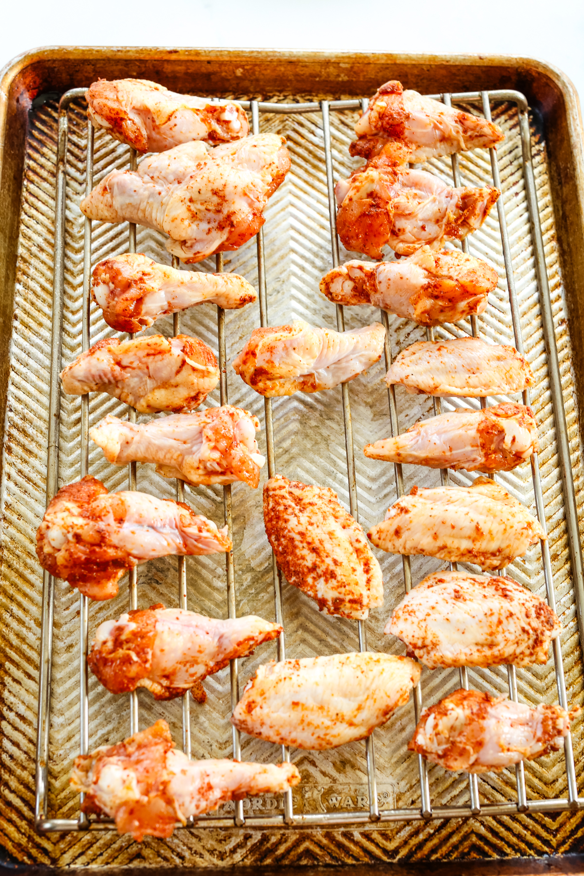raw chicken wings on a wire rack