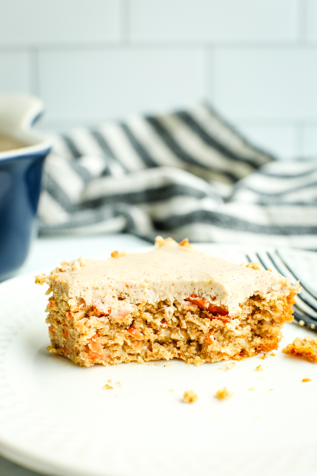 a square of carrot cake baked oats with a bite out of it