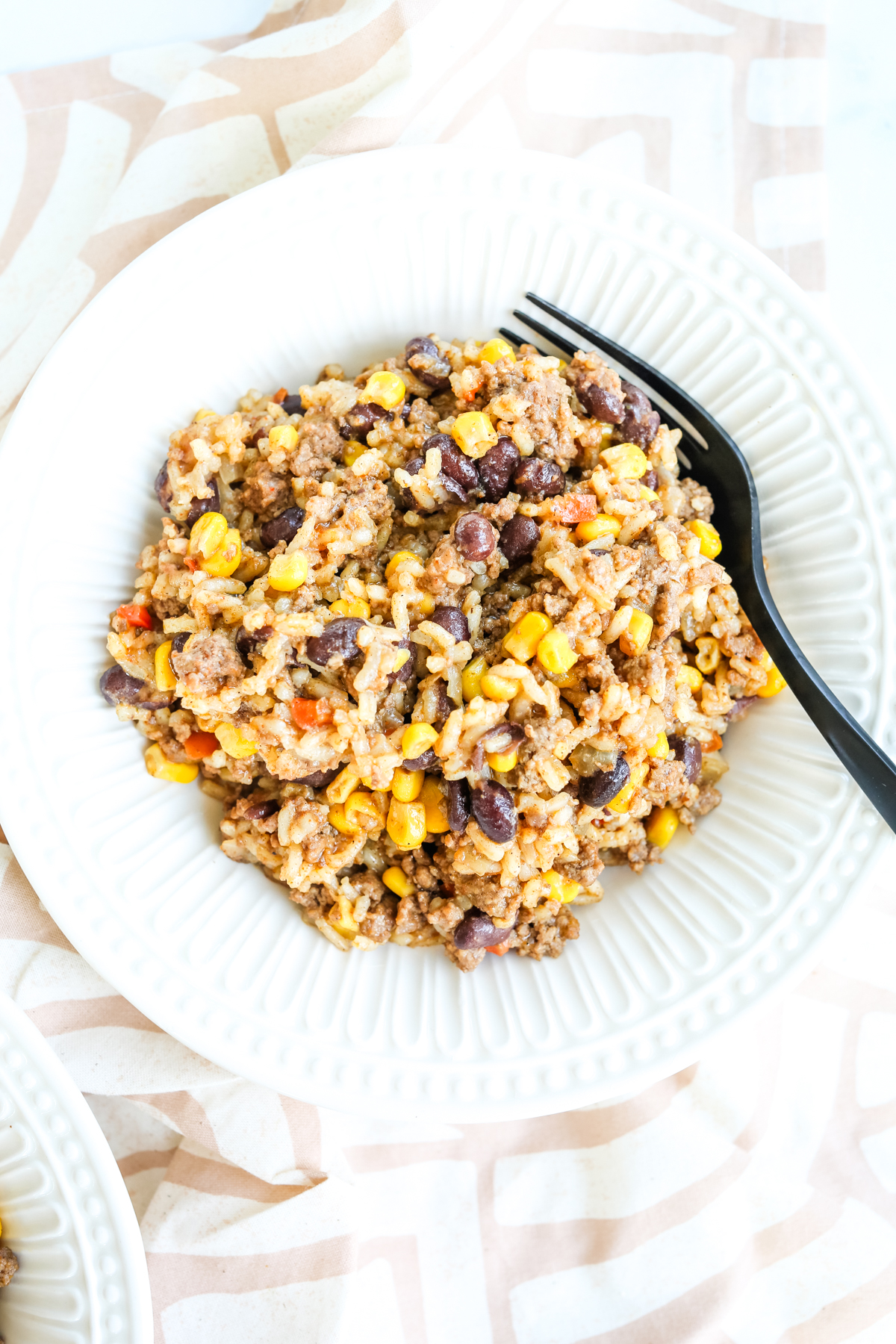 a bowl of the one pot dinner with a black spoon
