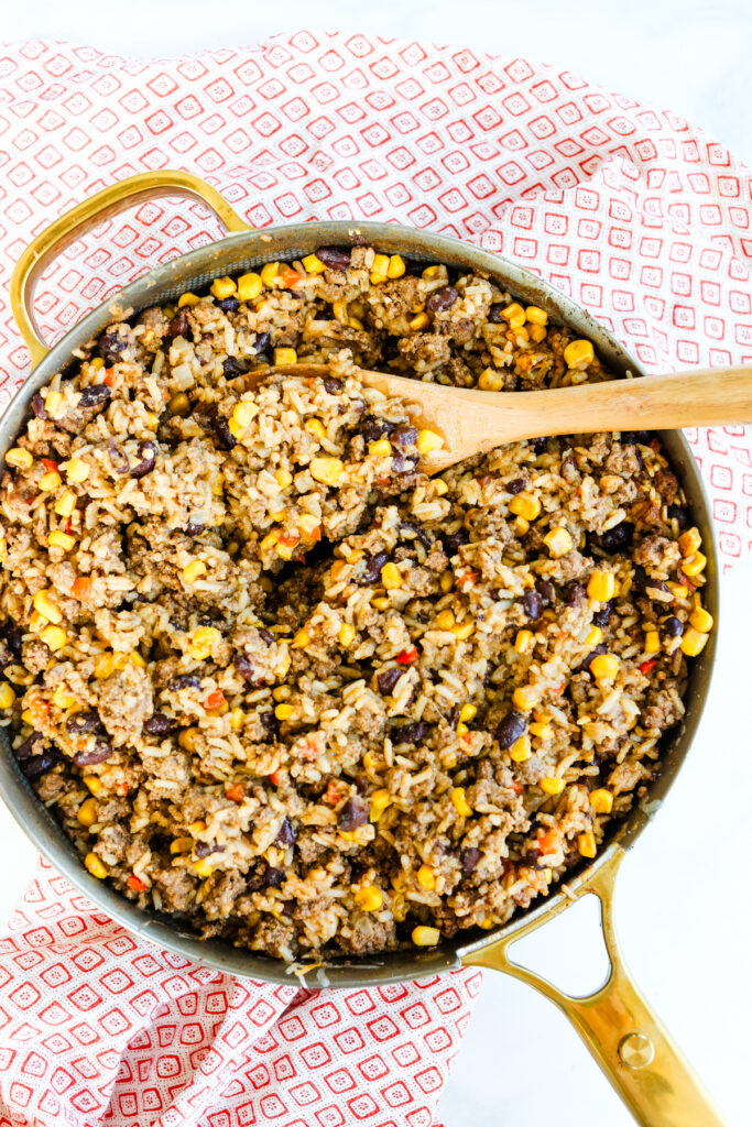 Mexican Beef Rice Skillet with a wooden spoon