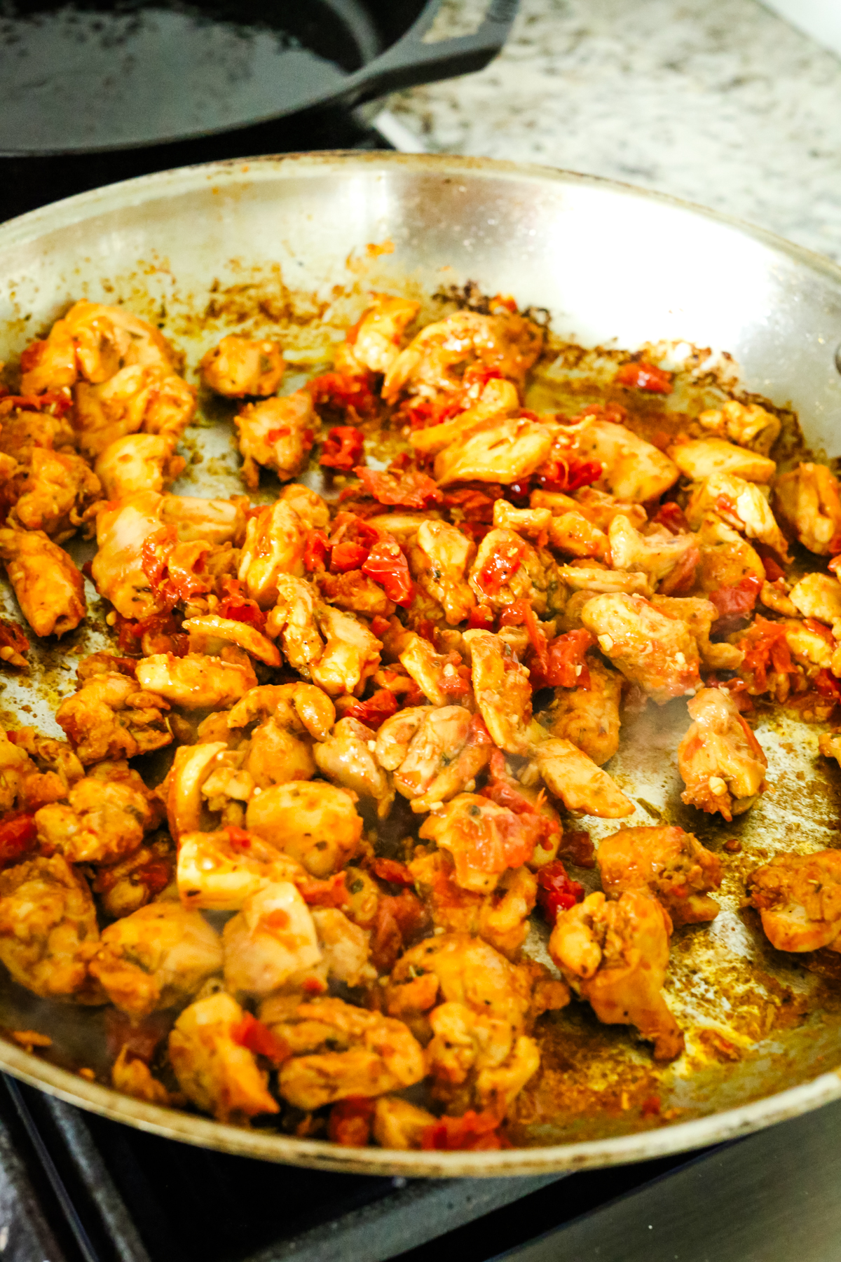 chicken and sundried tomatoes in a skillet