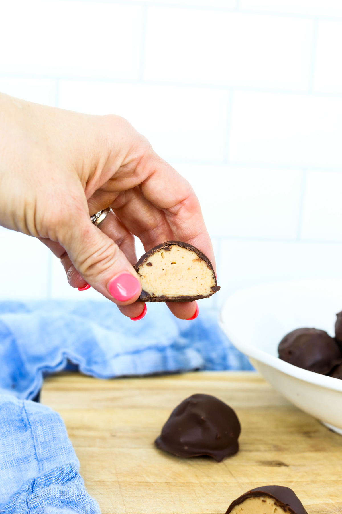 holding half of a peanut butter protein ball