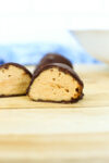 a peanut butter protein ball cut in half to show the inner creamy texture