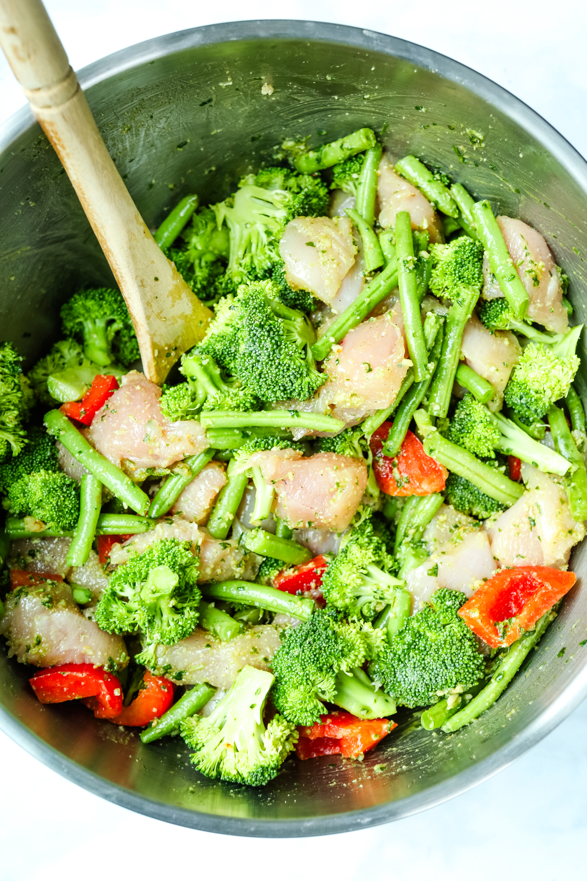 a big bowl combining vegetables and chicken