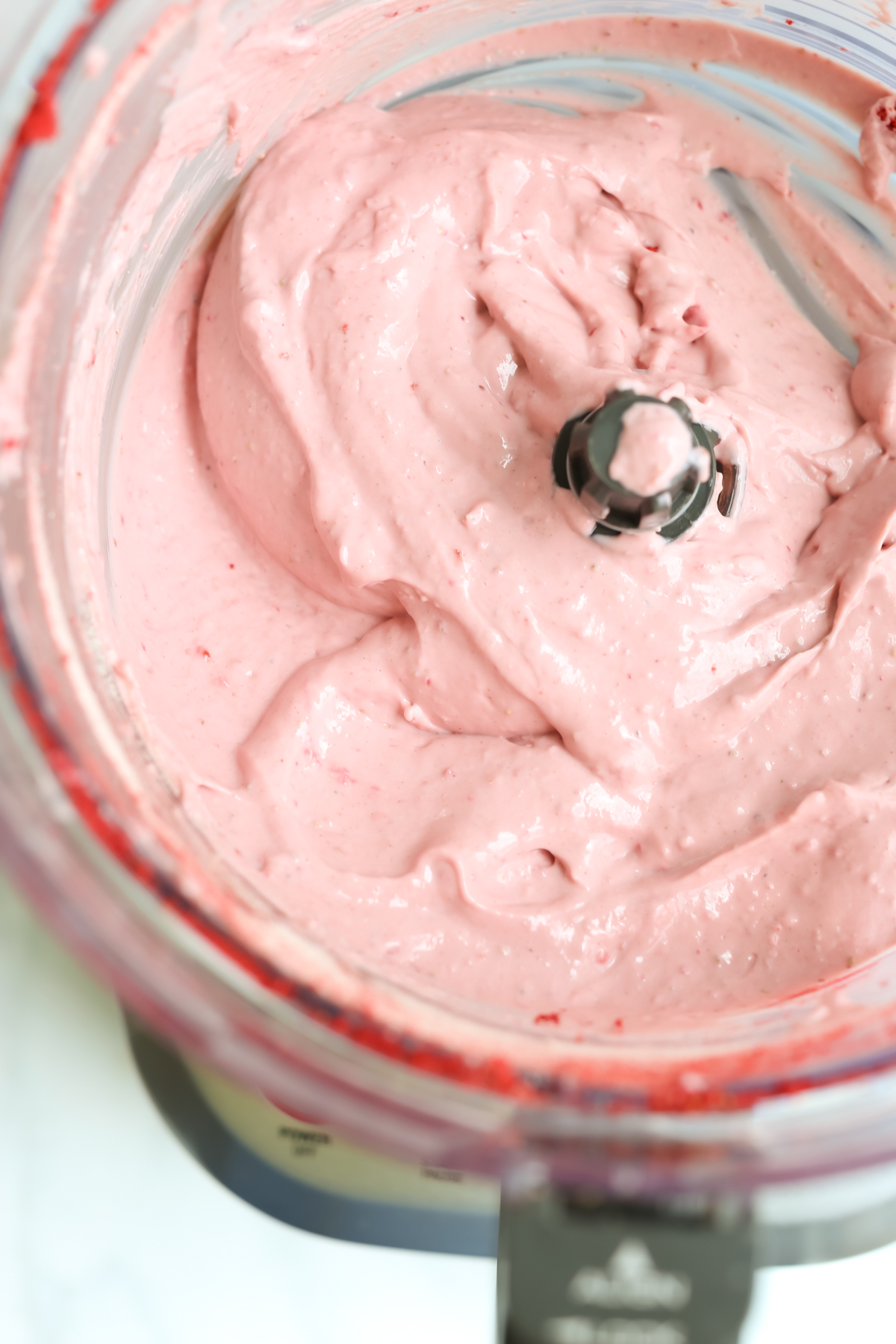 pink creamy mixture in a food processor 