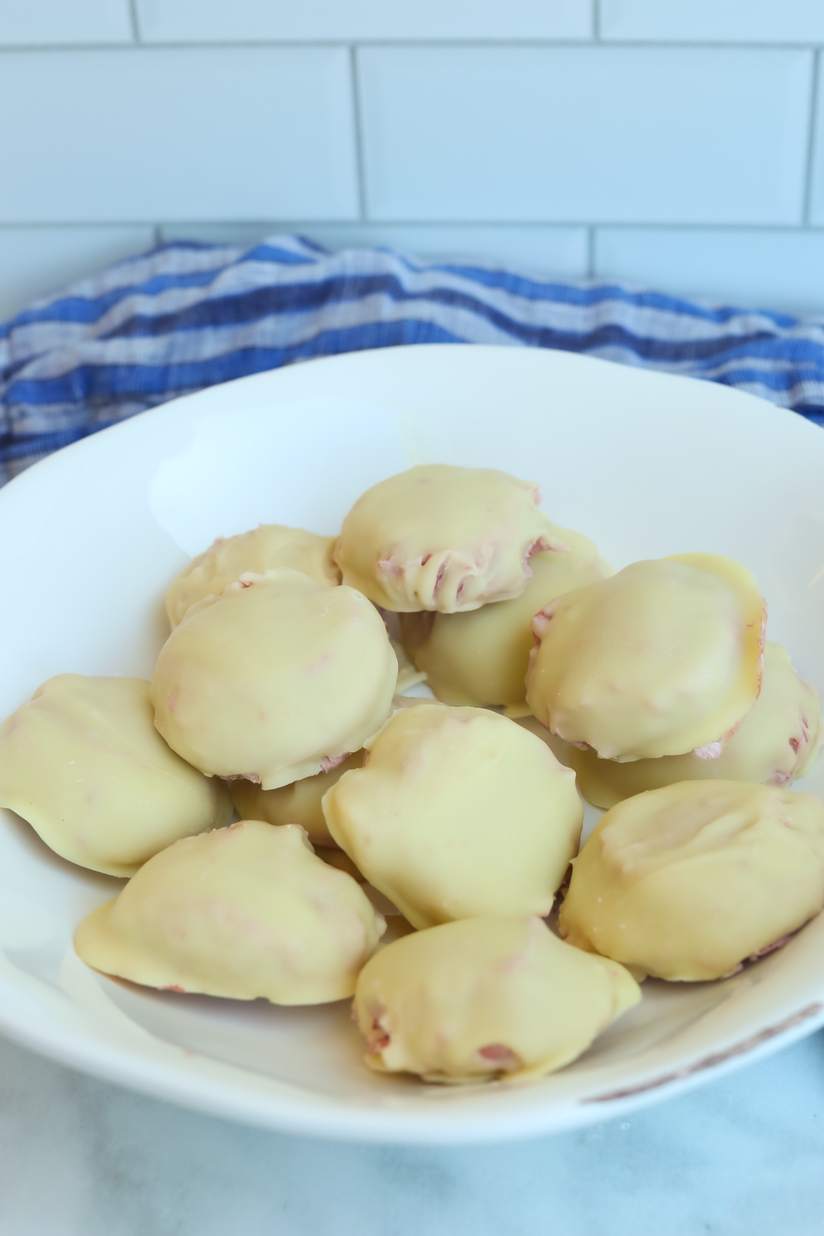 a white bowl filled with strawberry protein bites 