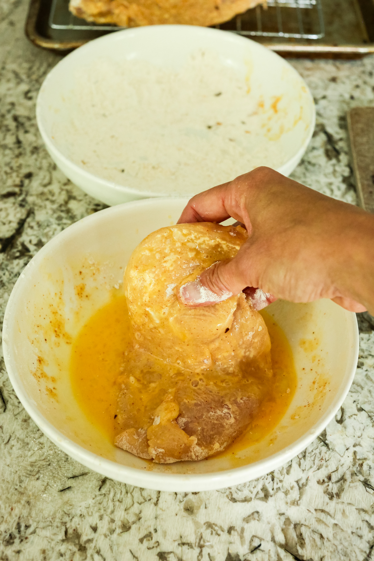 dipping chicken breast in egg