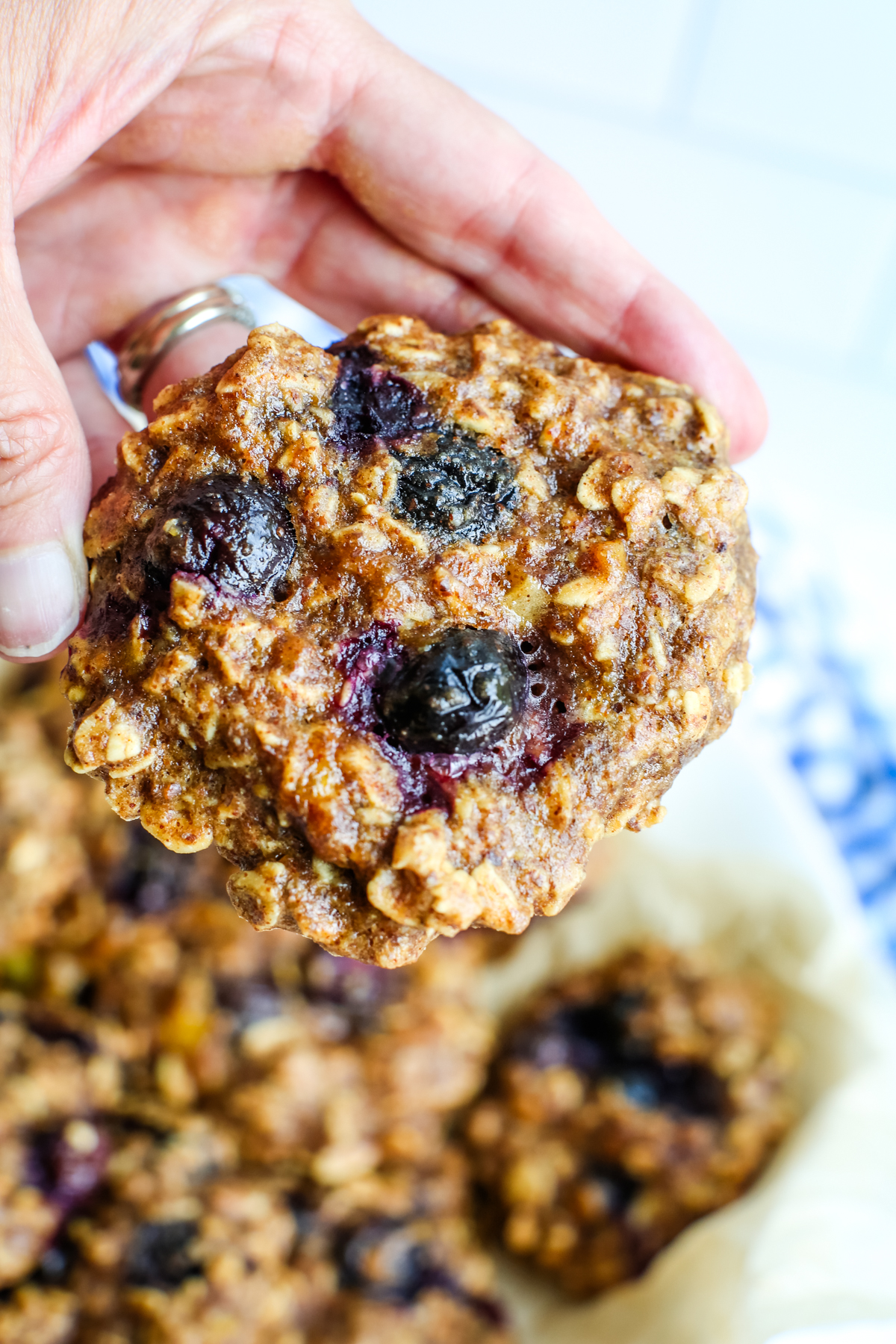 a close up shot of blueberry cookies being held in a hand