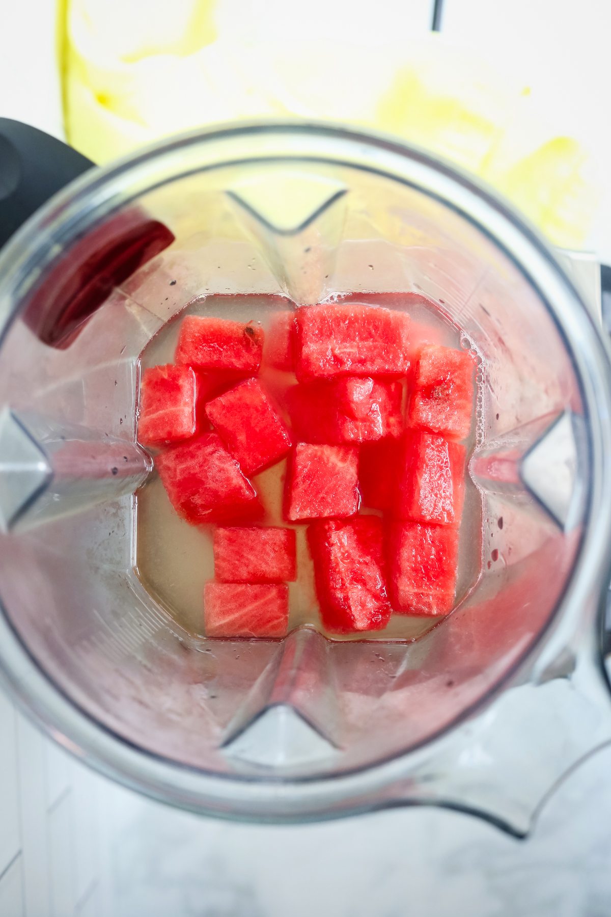 looking into the top of the blender with watermelon cubes