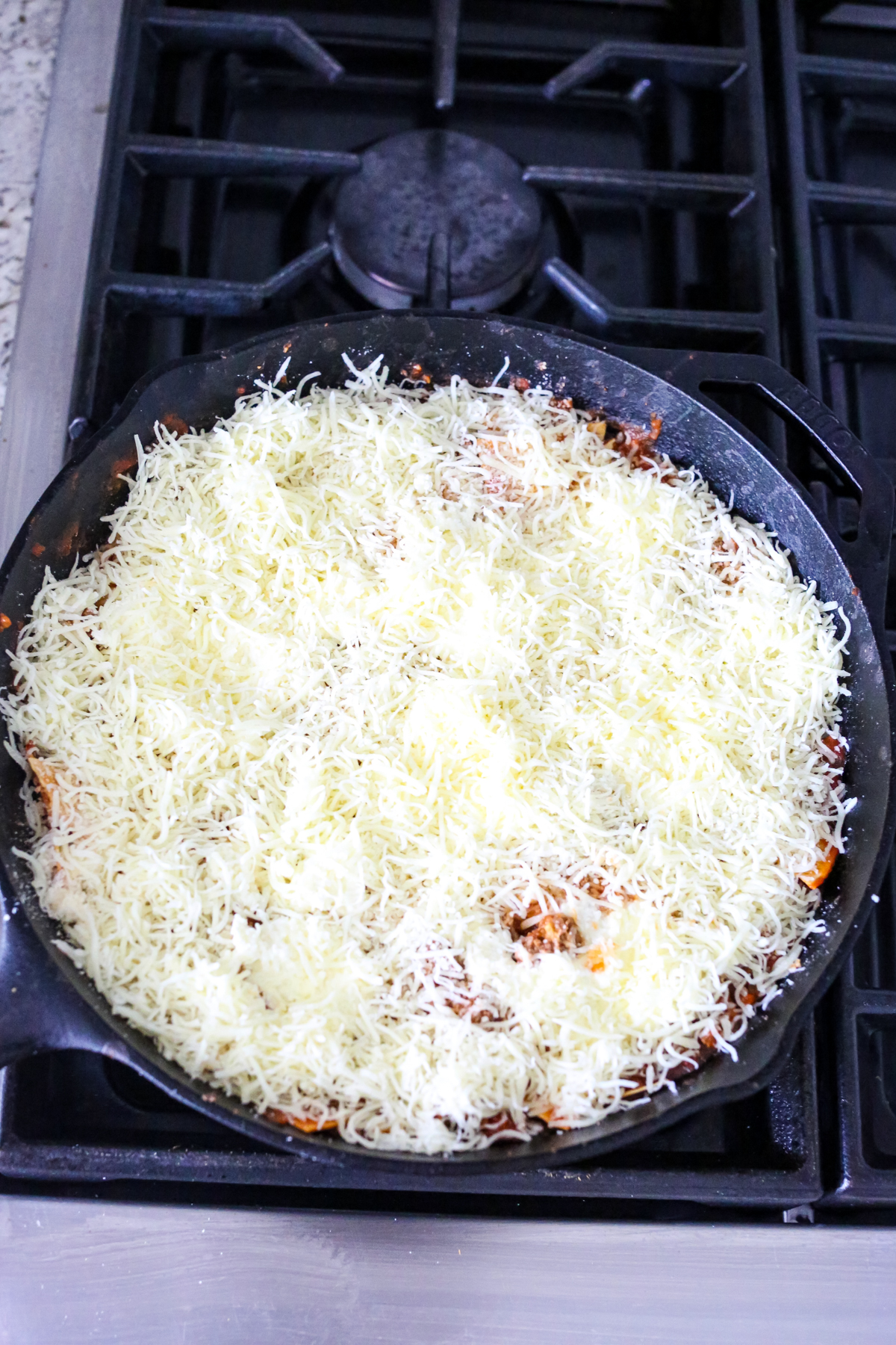 unbaked lasagna in cast iron skillet