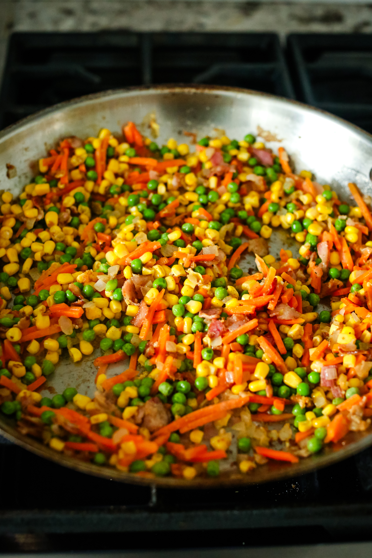 a large skillet with vegetables 