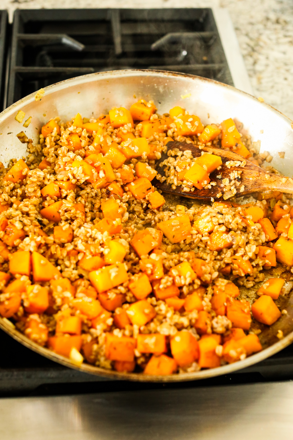 Butternut squash with farro in a large pan
