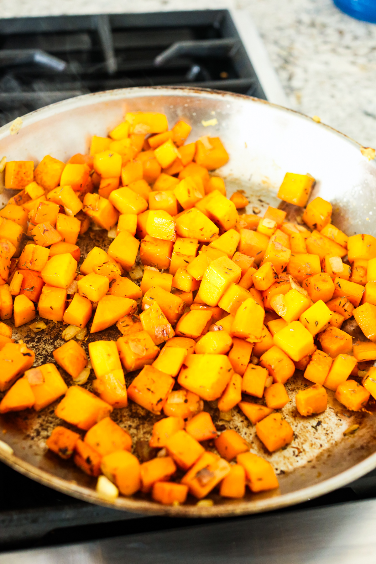 cubed butternut squash in a large skillet