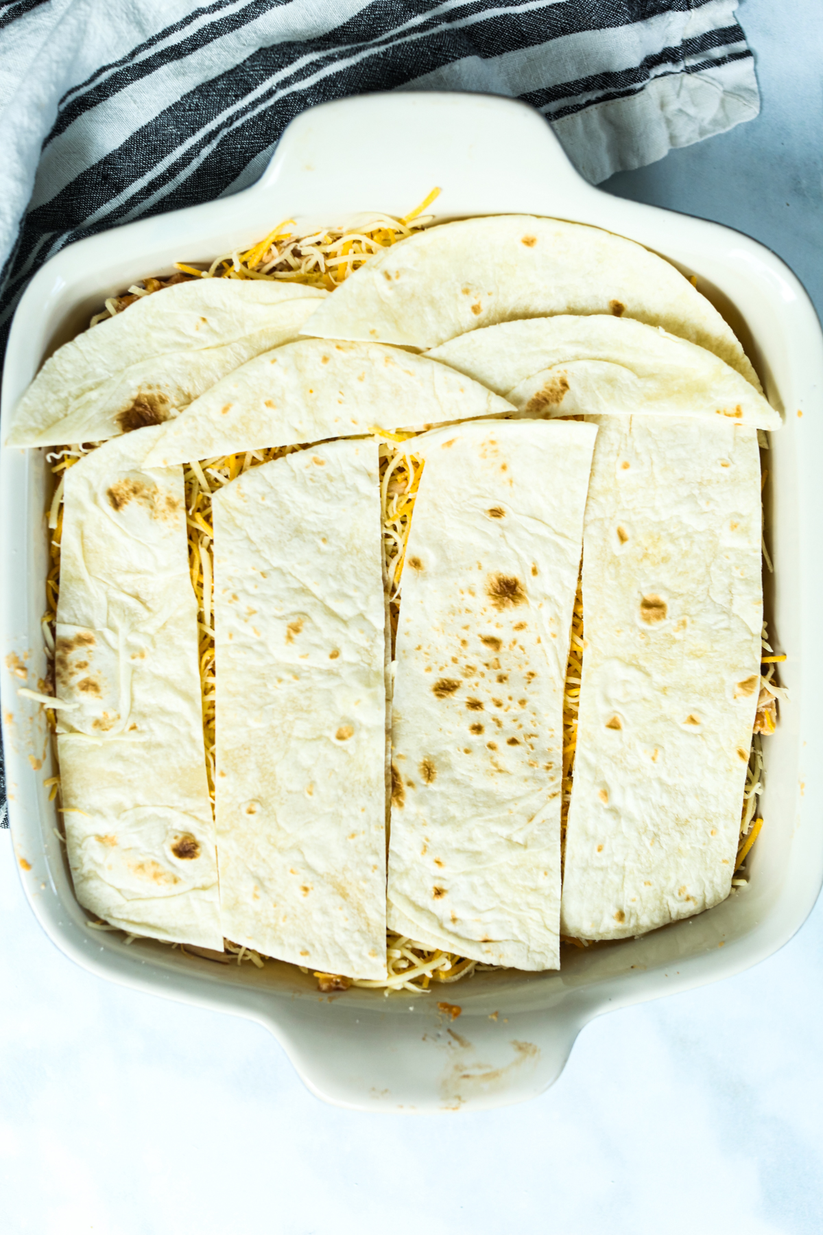 tortillas that have been cut to fit in casserole dish