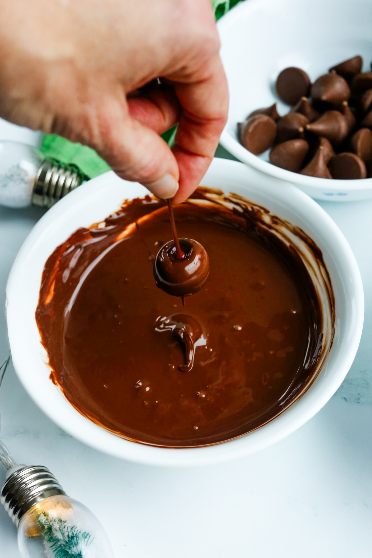 dipping a cherry in melted chocolate 