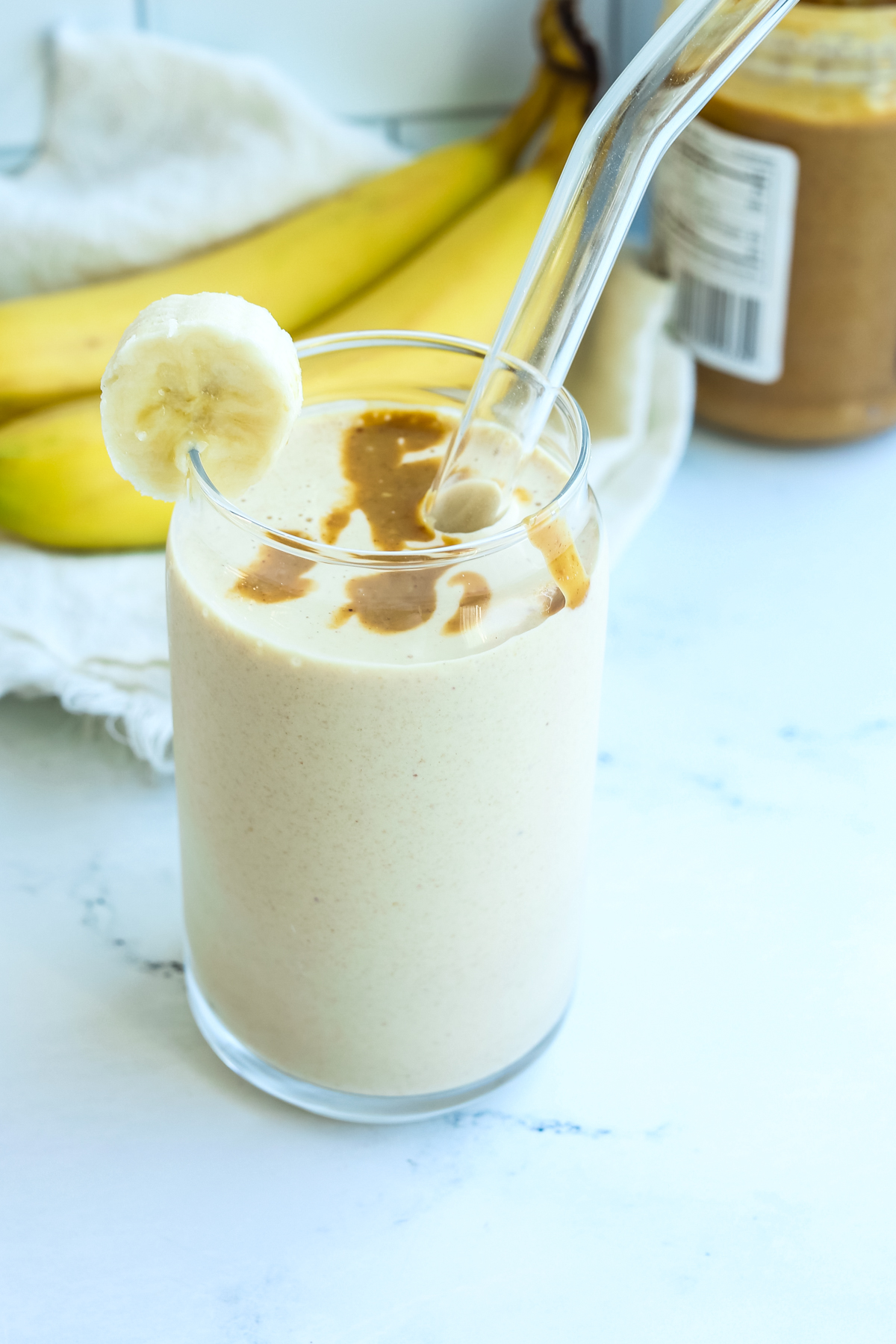 smoothie in a glass with a glass straw
