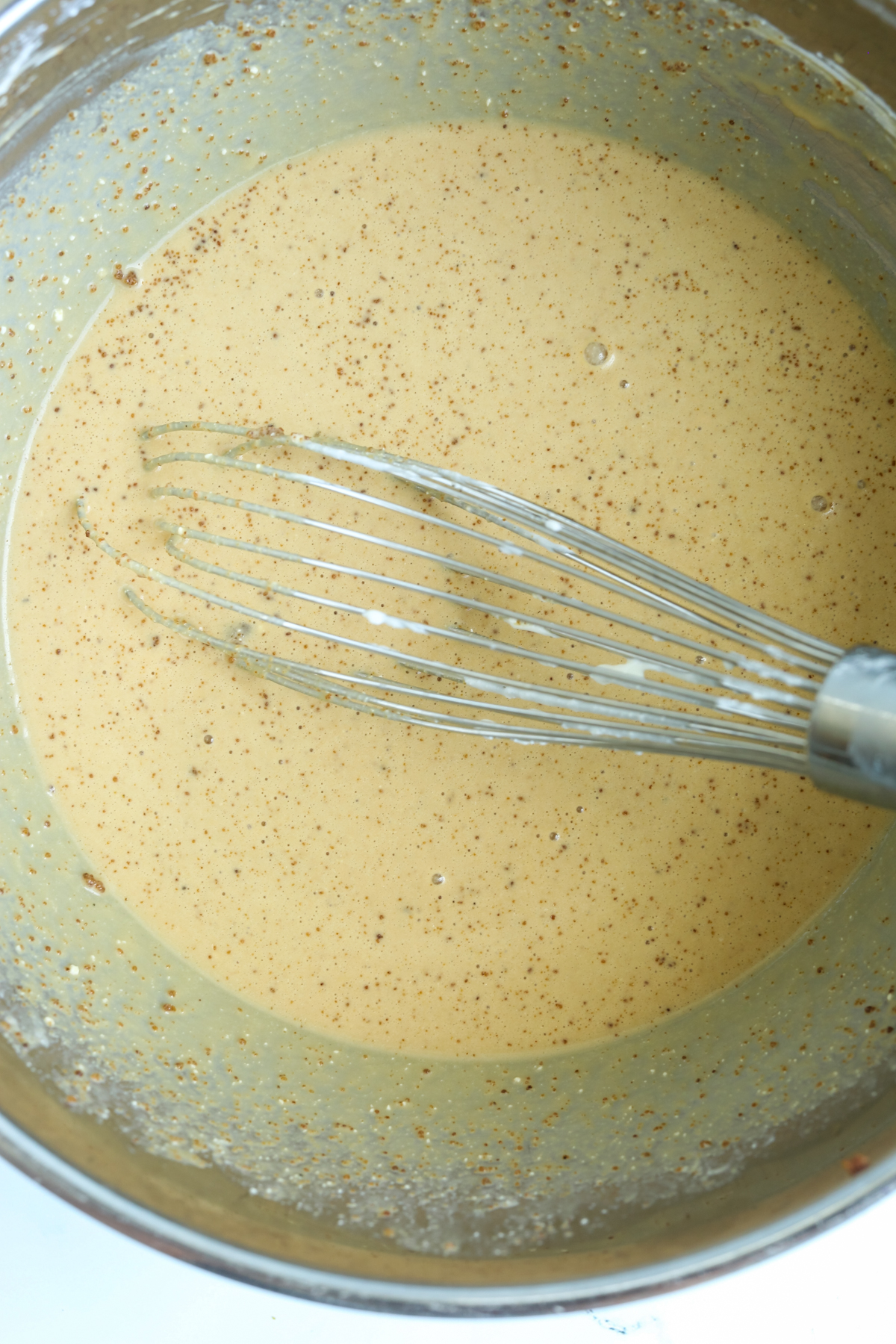 mixing wet ingredients with sugar in a bowl