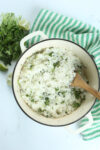 cilantro lime rice in a pot with a wooden spoon