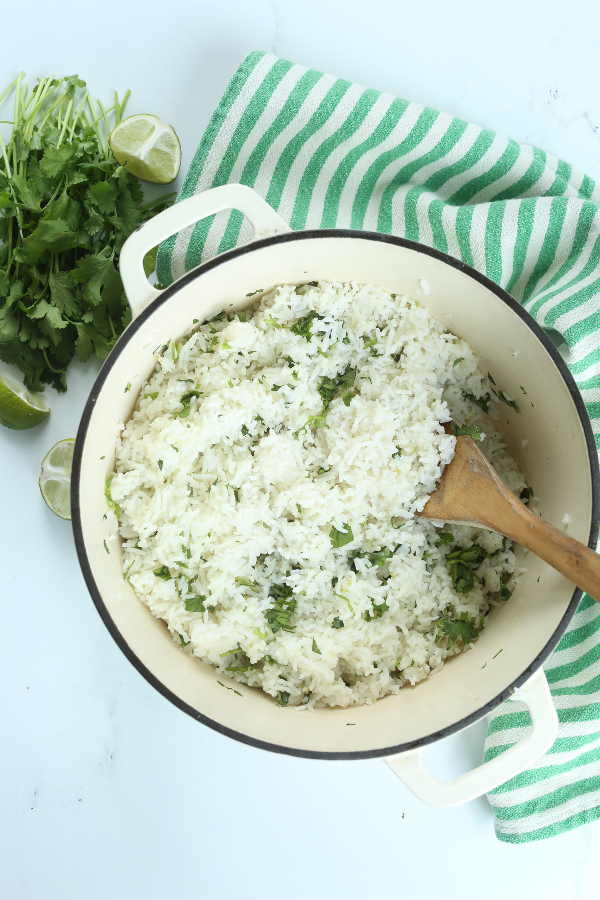 cilantro lime rice in a pot with a wooden spoon