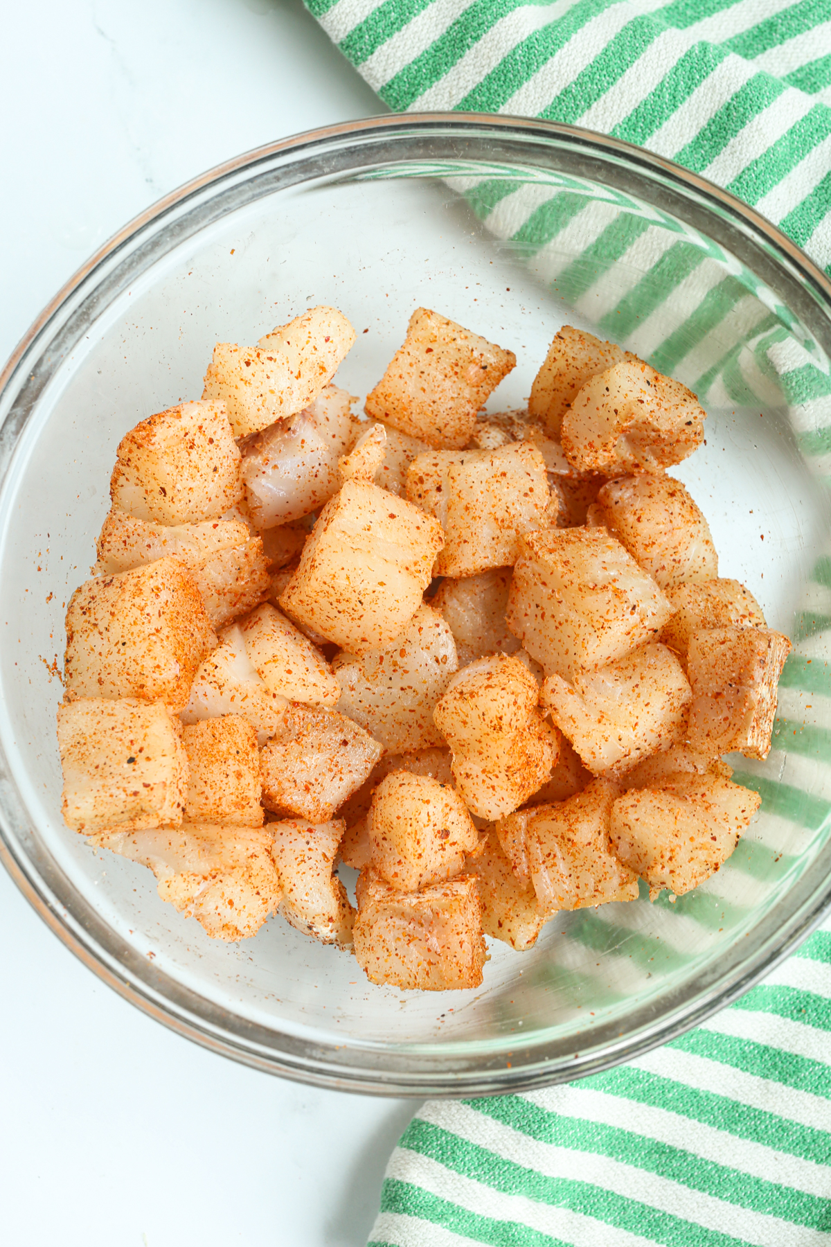 fish pieces in a bowl with seasoning 