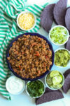 Loaded beef tacos with all the toppings on a table