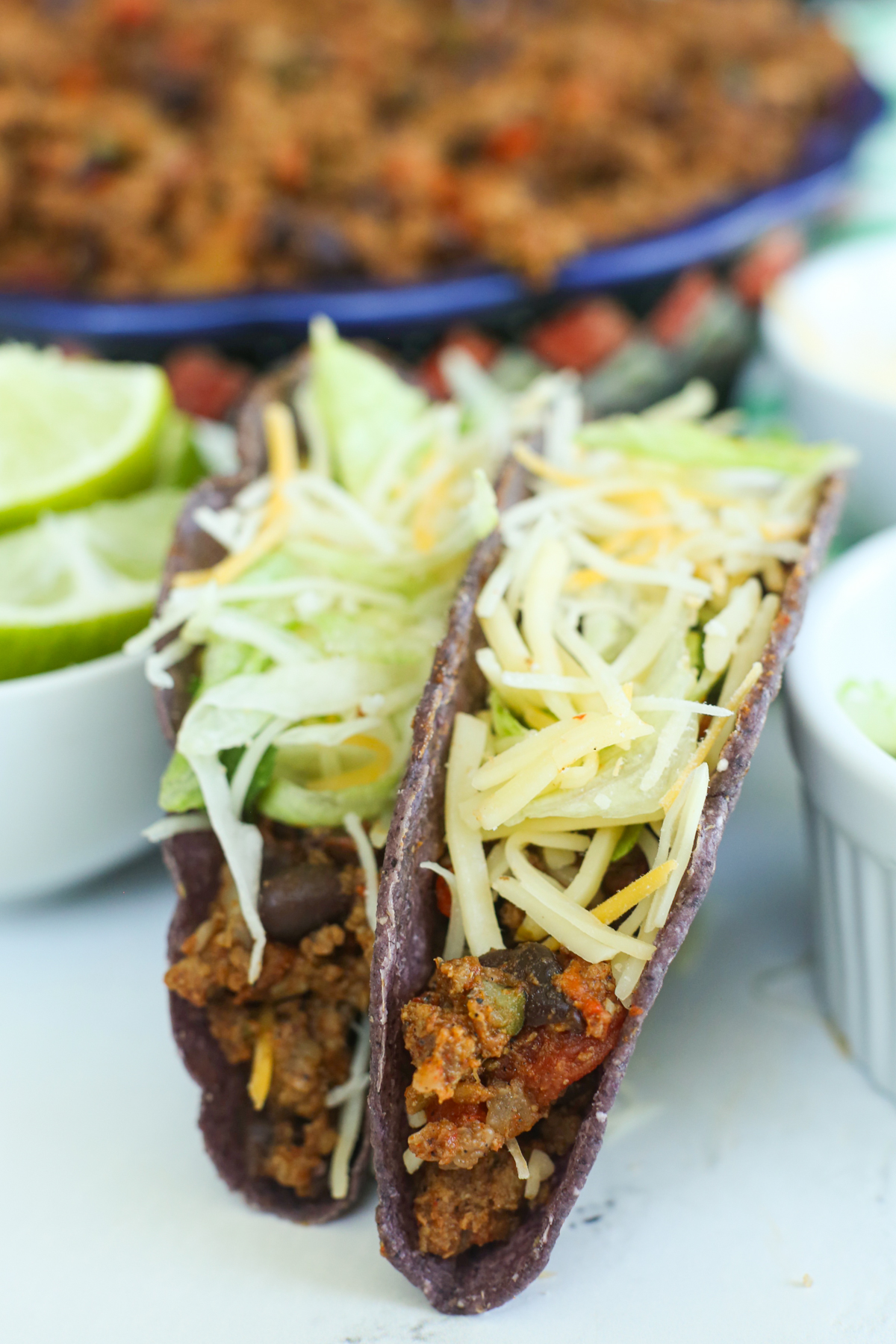 two beef tacos standing up