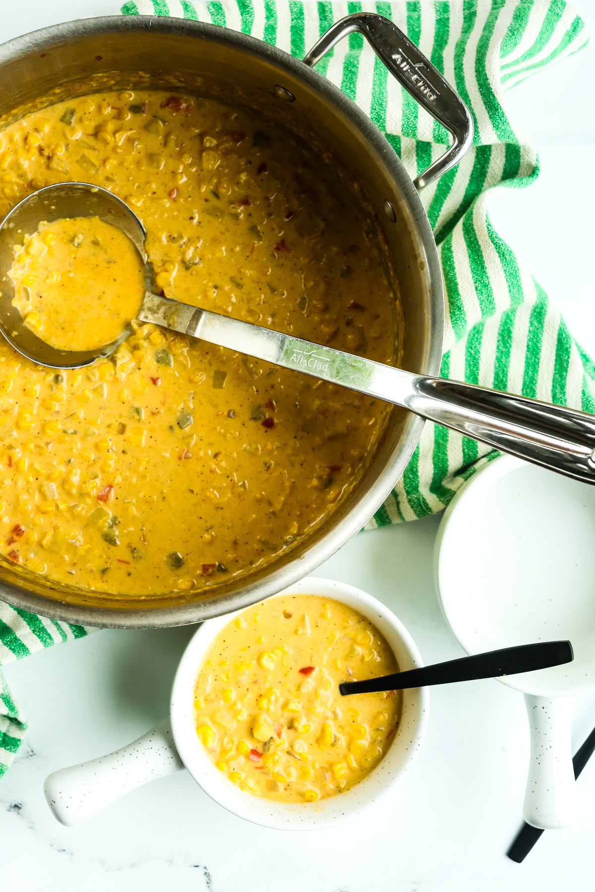 s big pot of Mexican street corn chowder with a bowl of it next to the pot