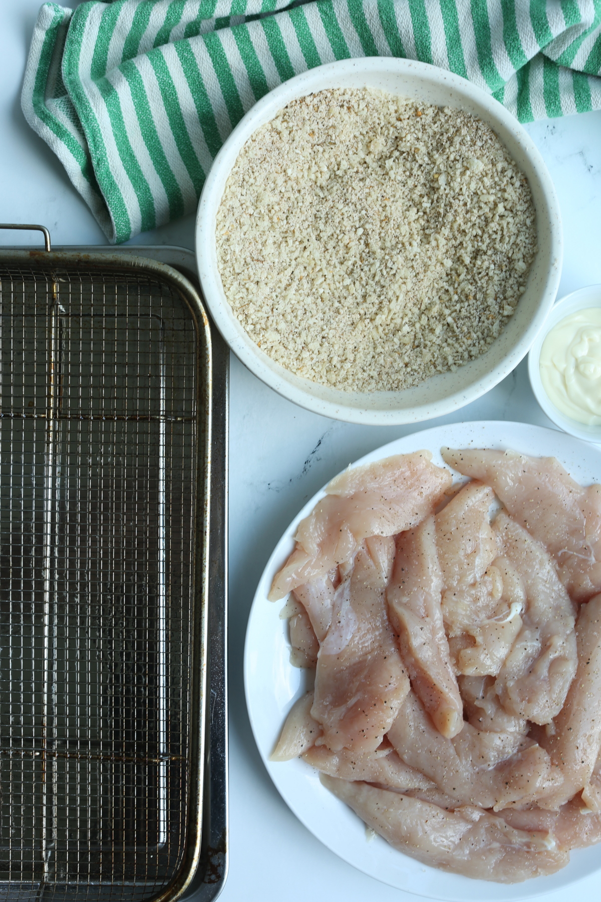 raw chicken with bread crumbs ready to be coated