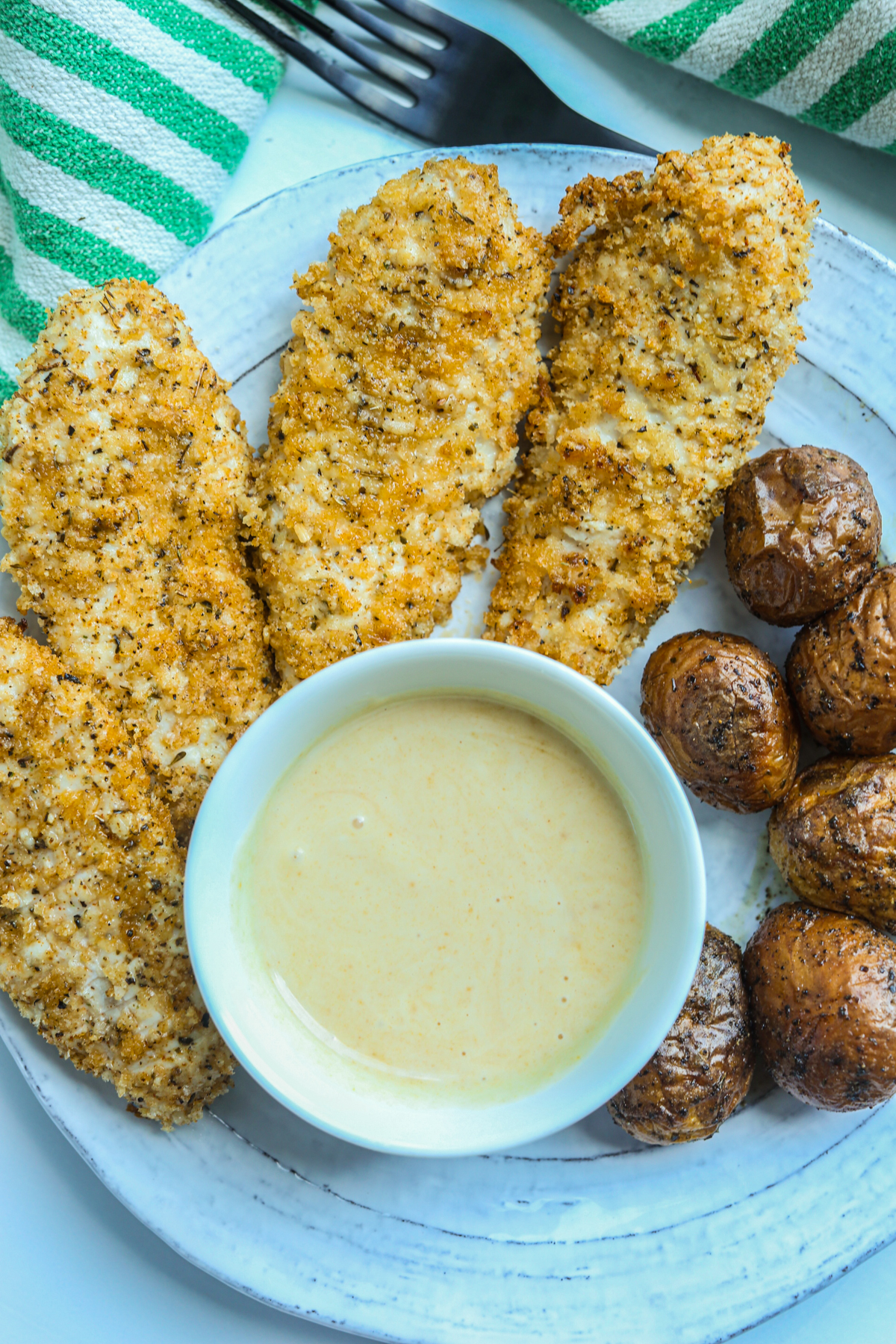 a plate of air fryer chicken tenders with potatoes